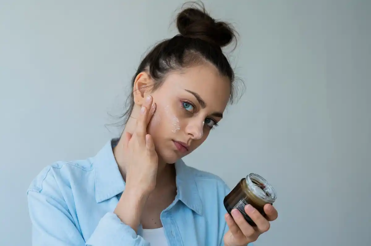 woman looking worriedly at face cream ingredient label
