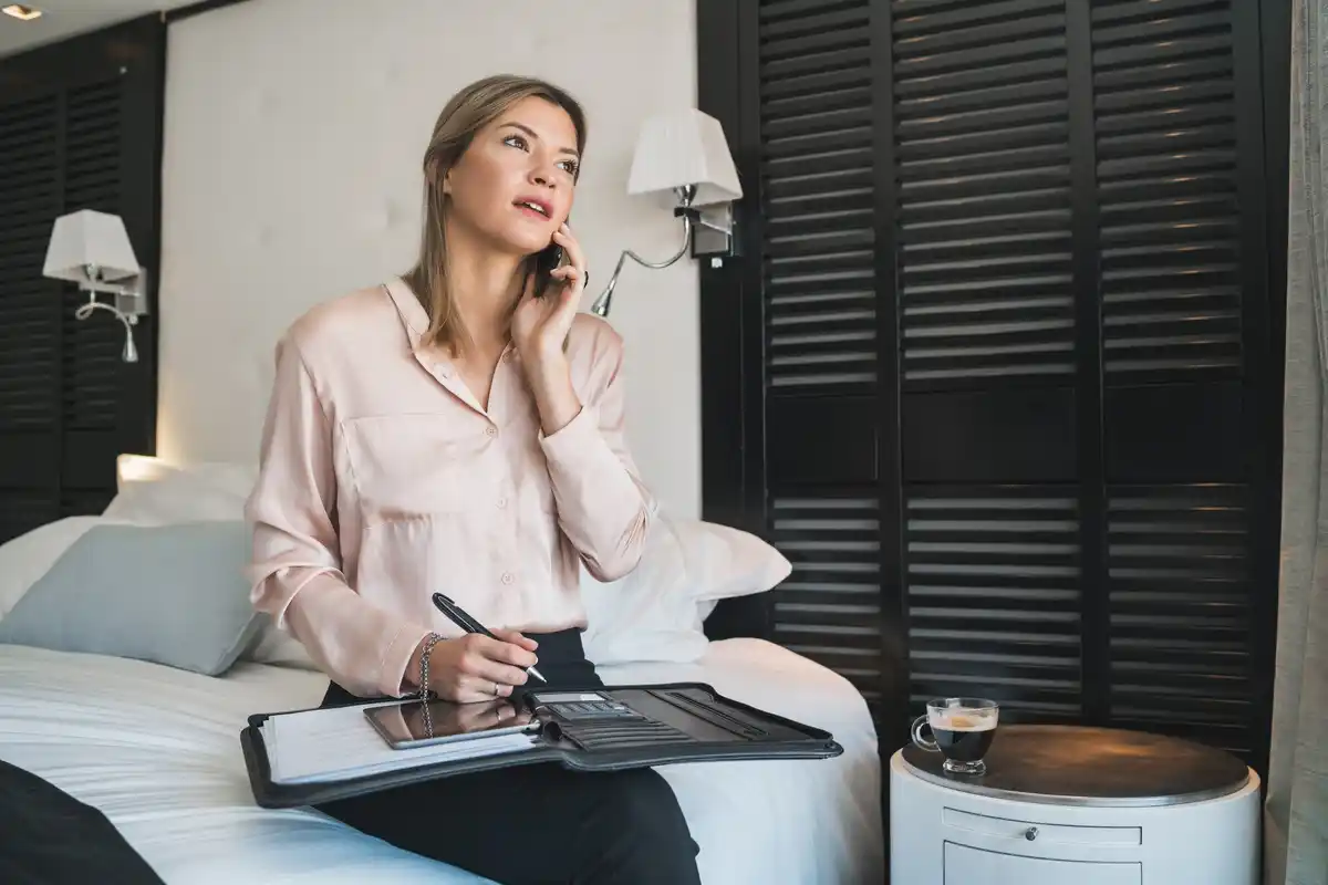 traveler using extension cord in hotel room