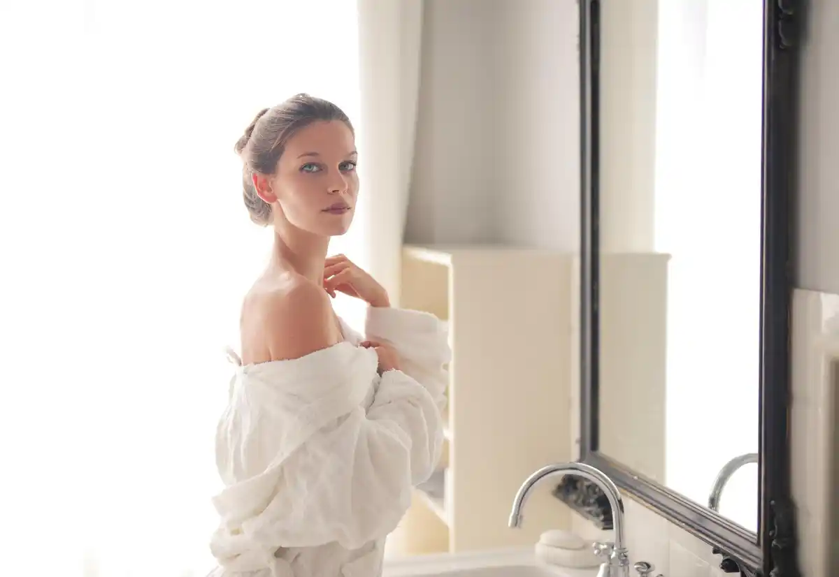 middle aged czech woman skincare routine bathroom mirror soft natural light