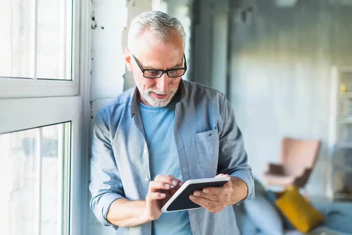 Czech mature man using smartphone finance control
