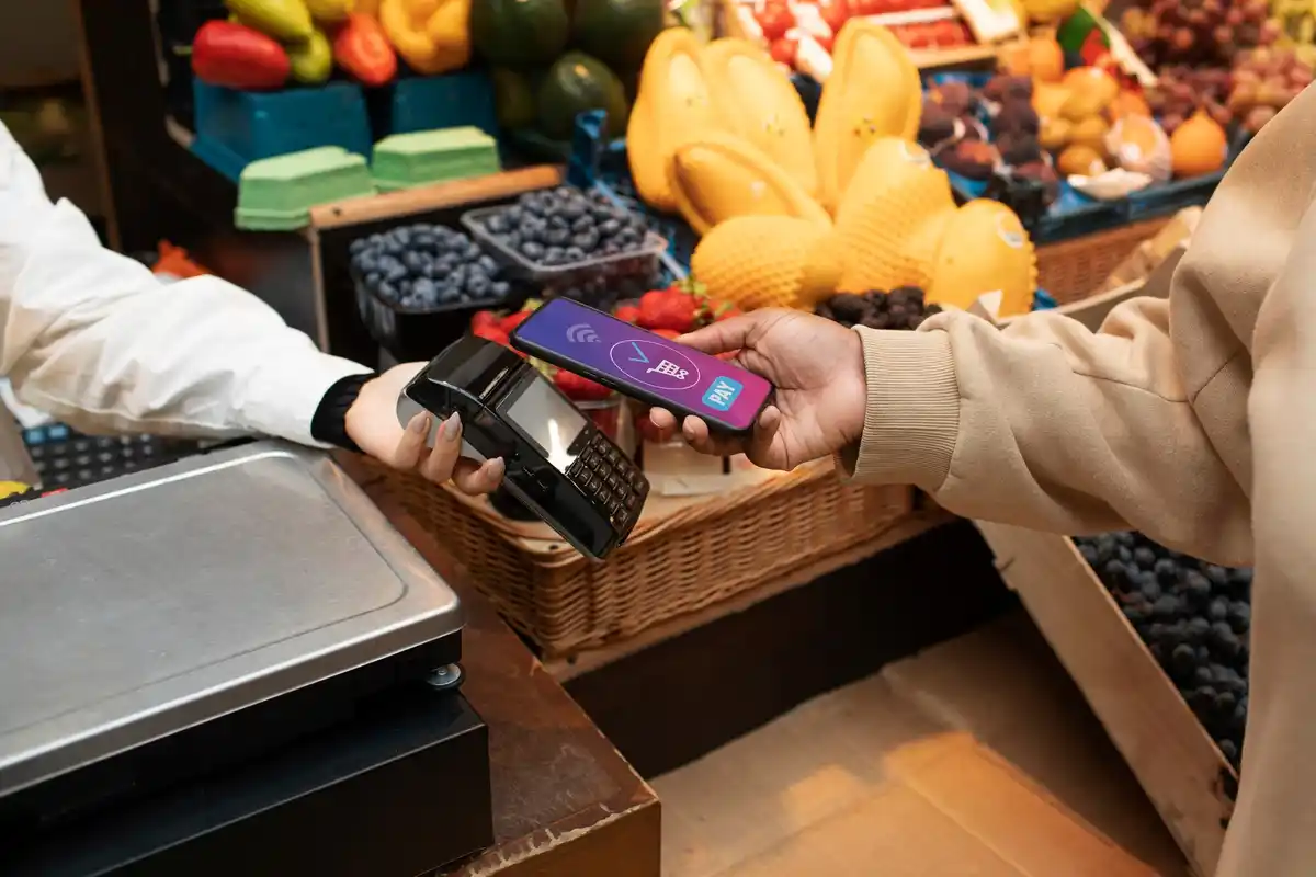 Czech man paying with smartphone in local market