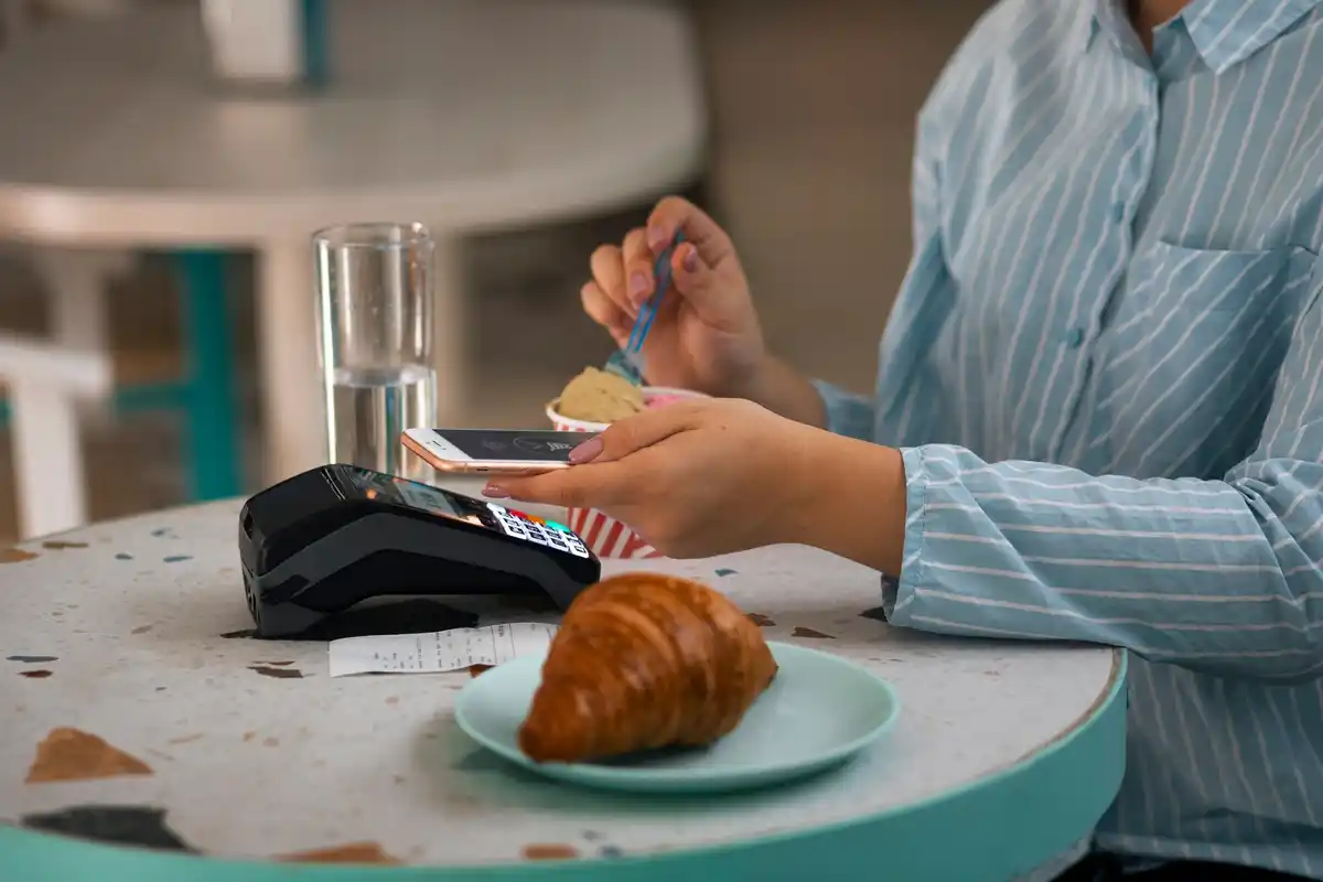 Czech cafe payment with QR code and mobile app on wooden table
