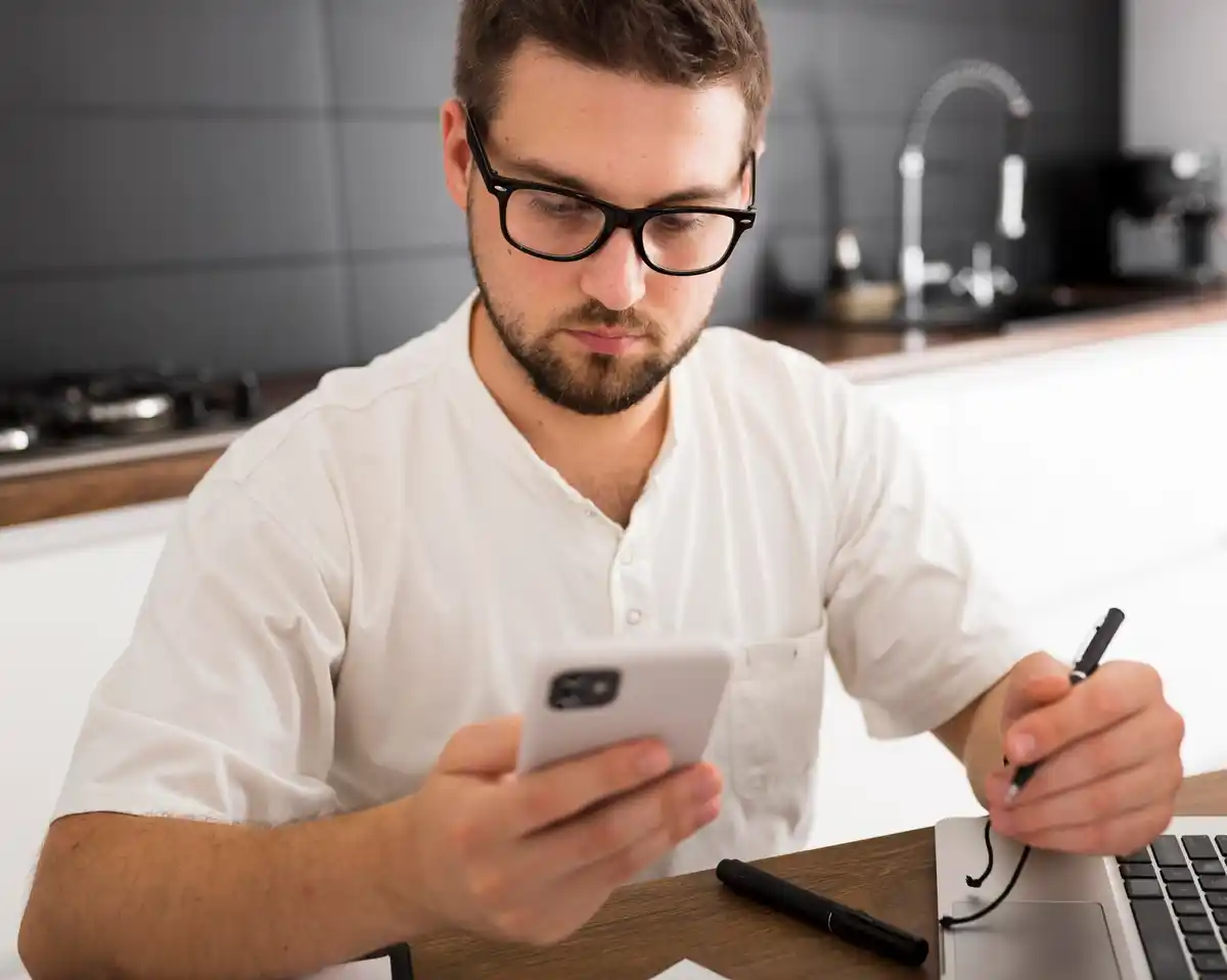 Czech man checking online banking sitting at kitchen table