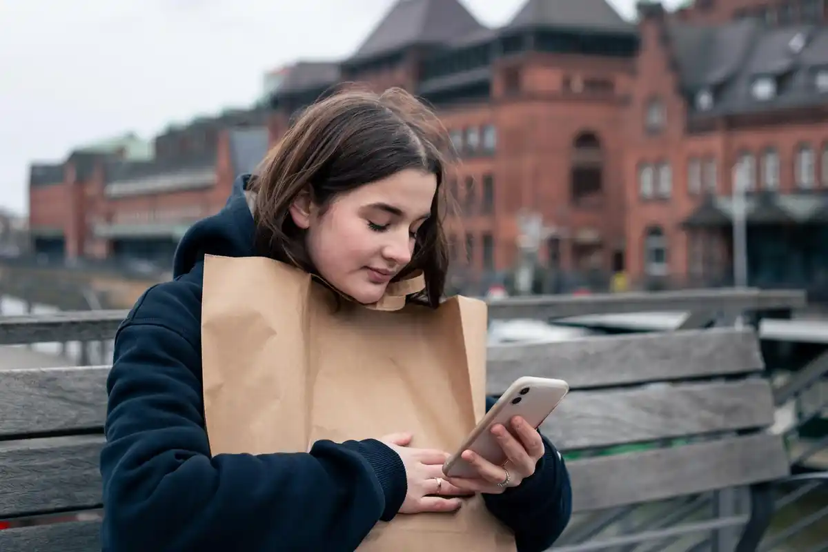 young person looking at phone notification stress czech street