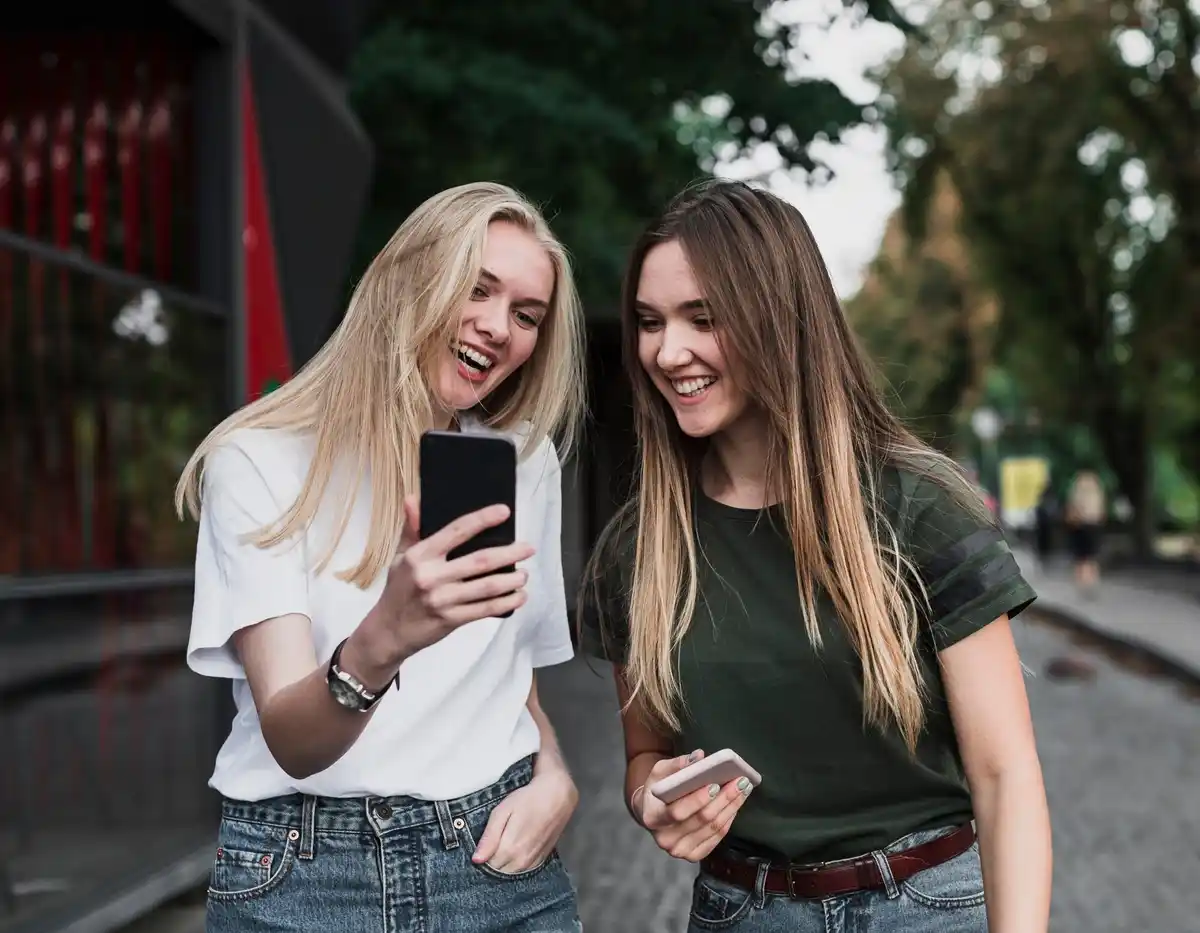 Czech teenagers using smartphones chatting