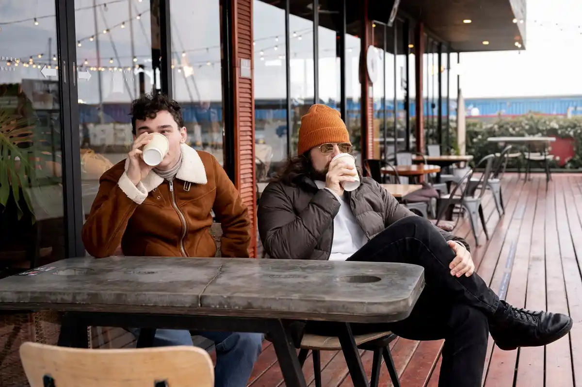 sad couple sitting apart in modern Prague cafe