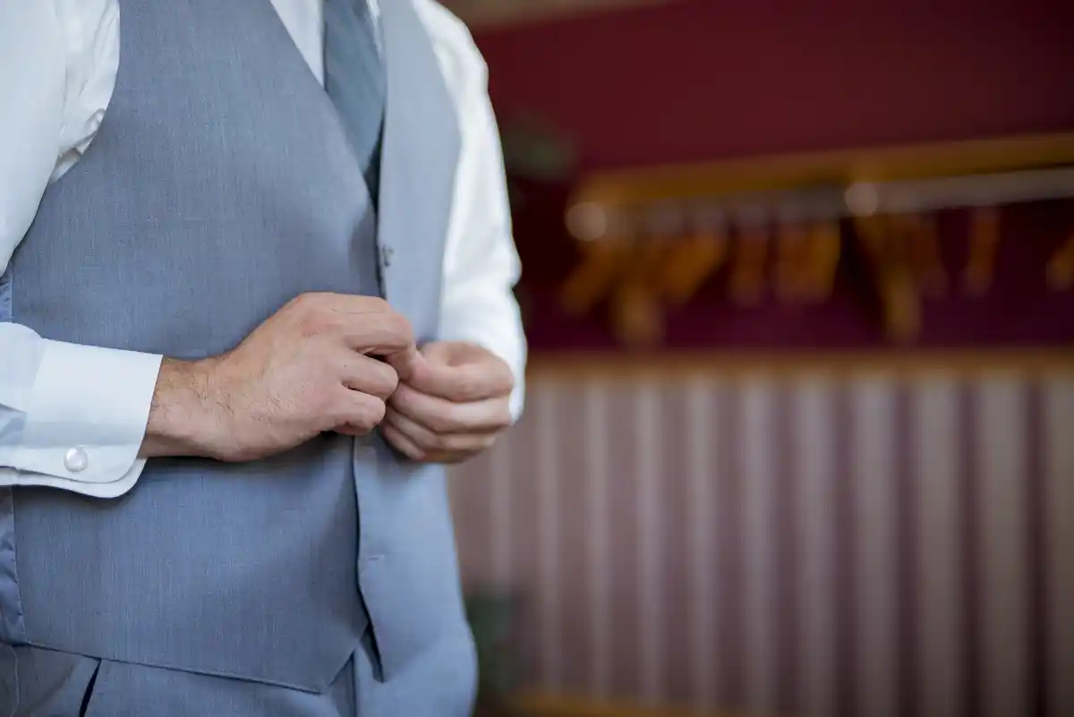 man with hands in pockets at business meeting
