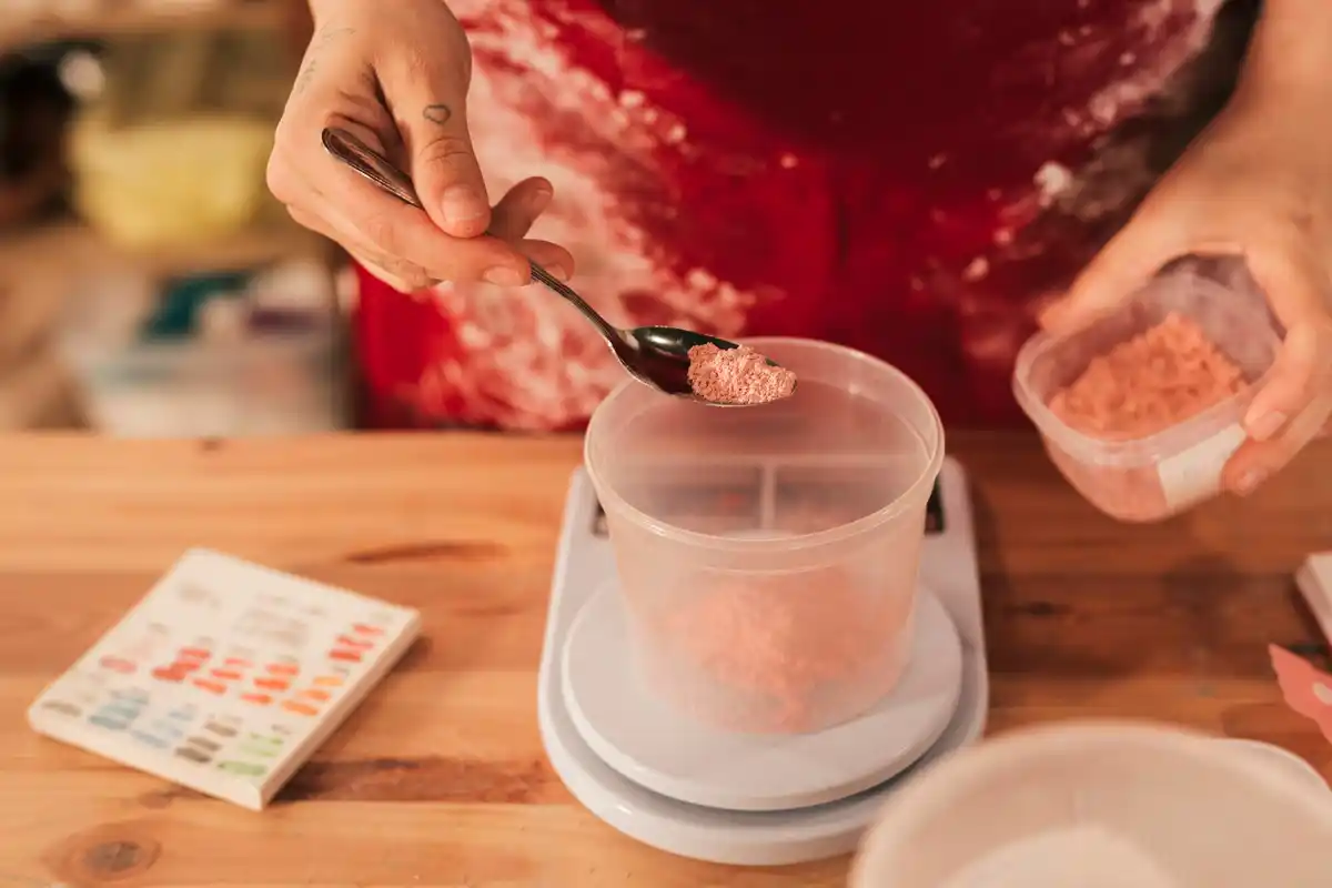 grandma adding sugar cube to tomato sauce Czech kitchen