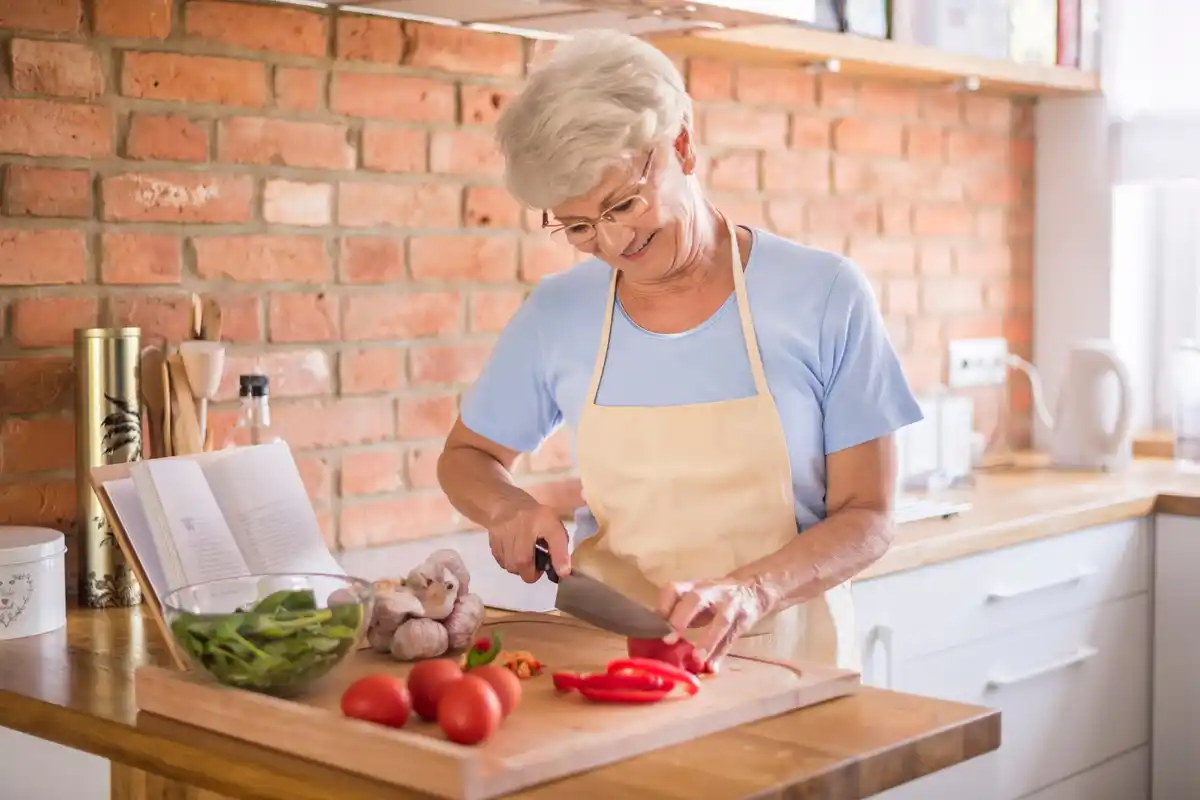 Czech grandmother cooking tomato sauce traditional kitchen