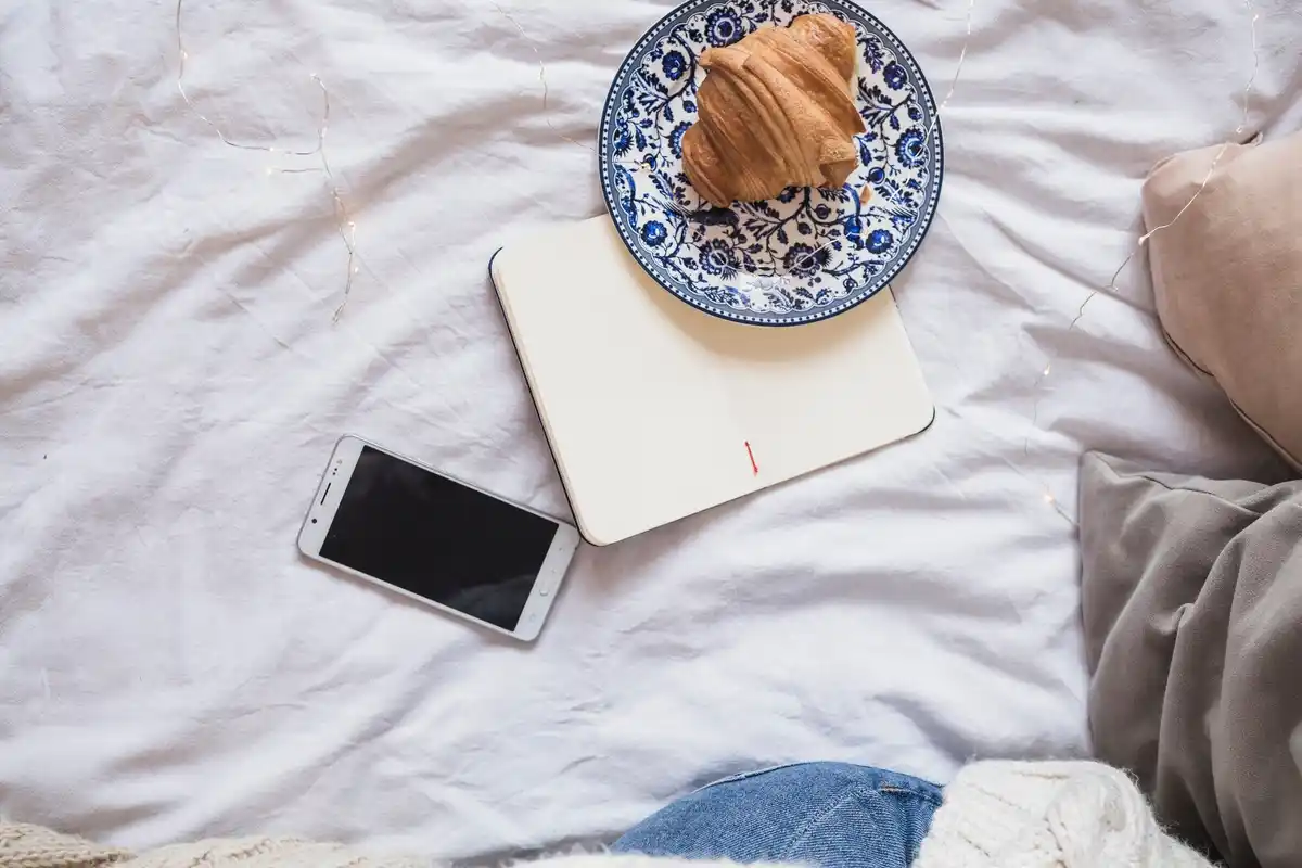 wireless charging pad with smartphone in cozy cafe table