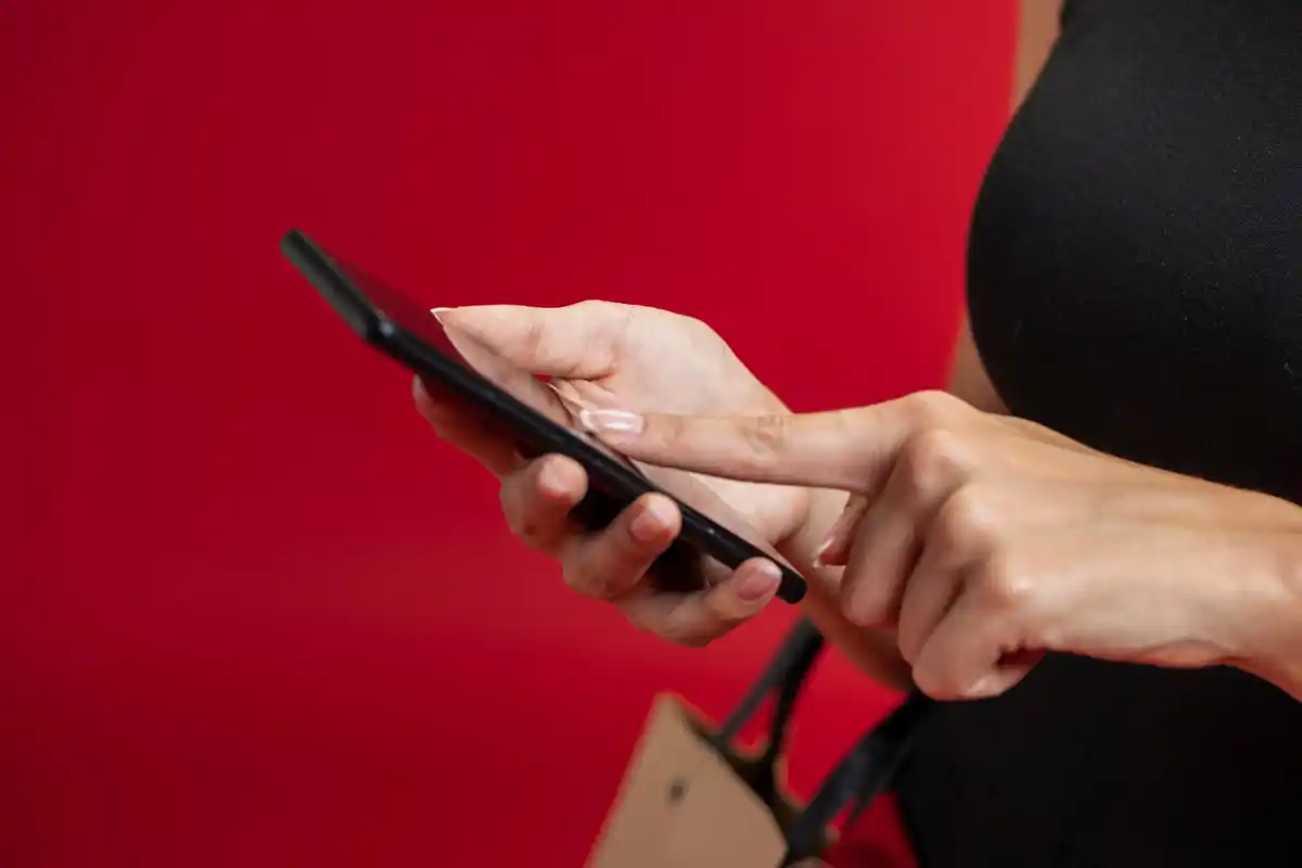 close up finger pressing side button smartphone