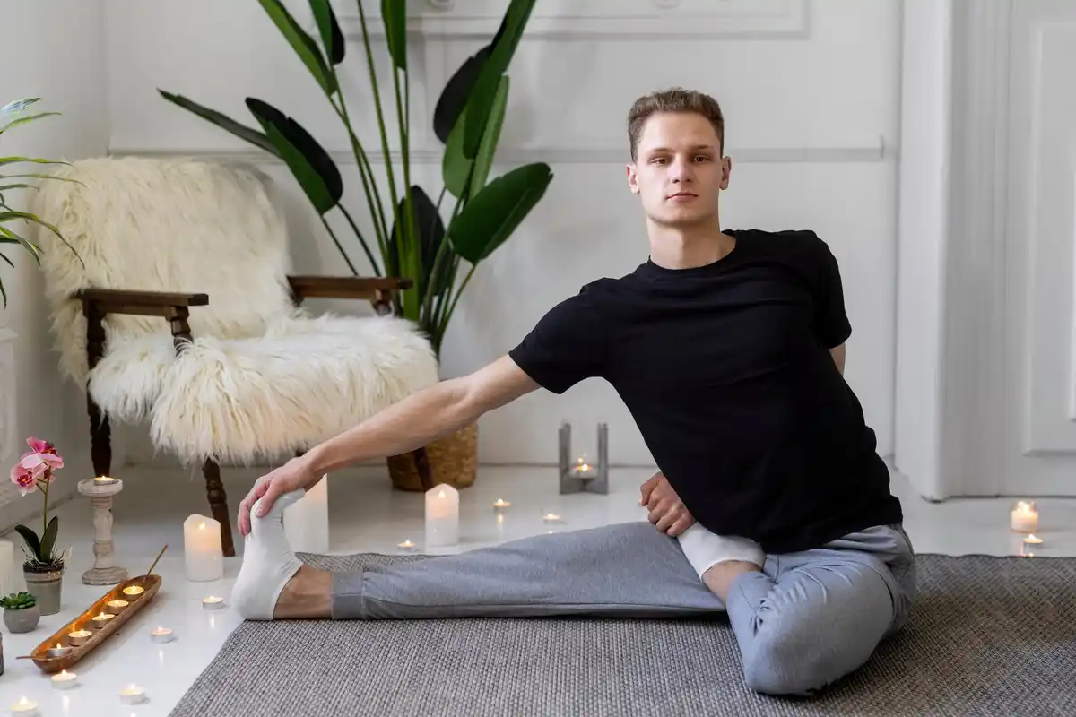 Czech man 40s yoga stretching home interior sunlight