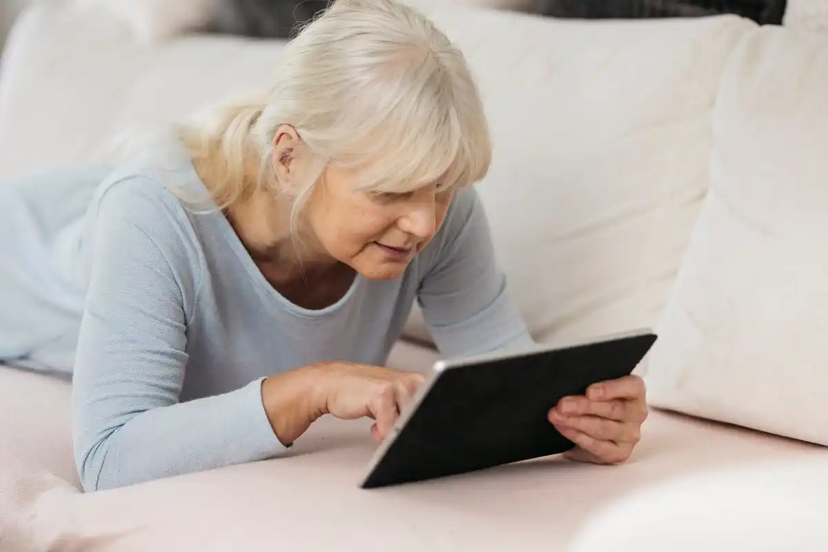 active senior using tablet in cozy home Czech