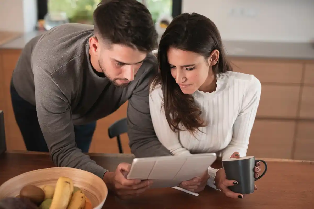 Czech family using envelope budgeting method at home, kitchen table, money