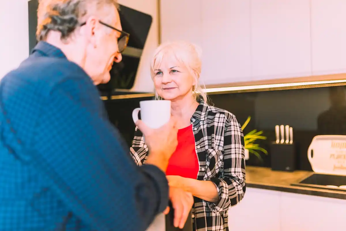 old couple czech discussing home finances kitchen casual