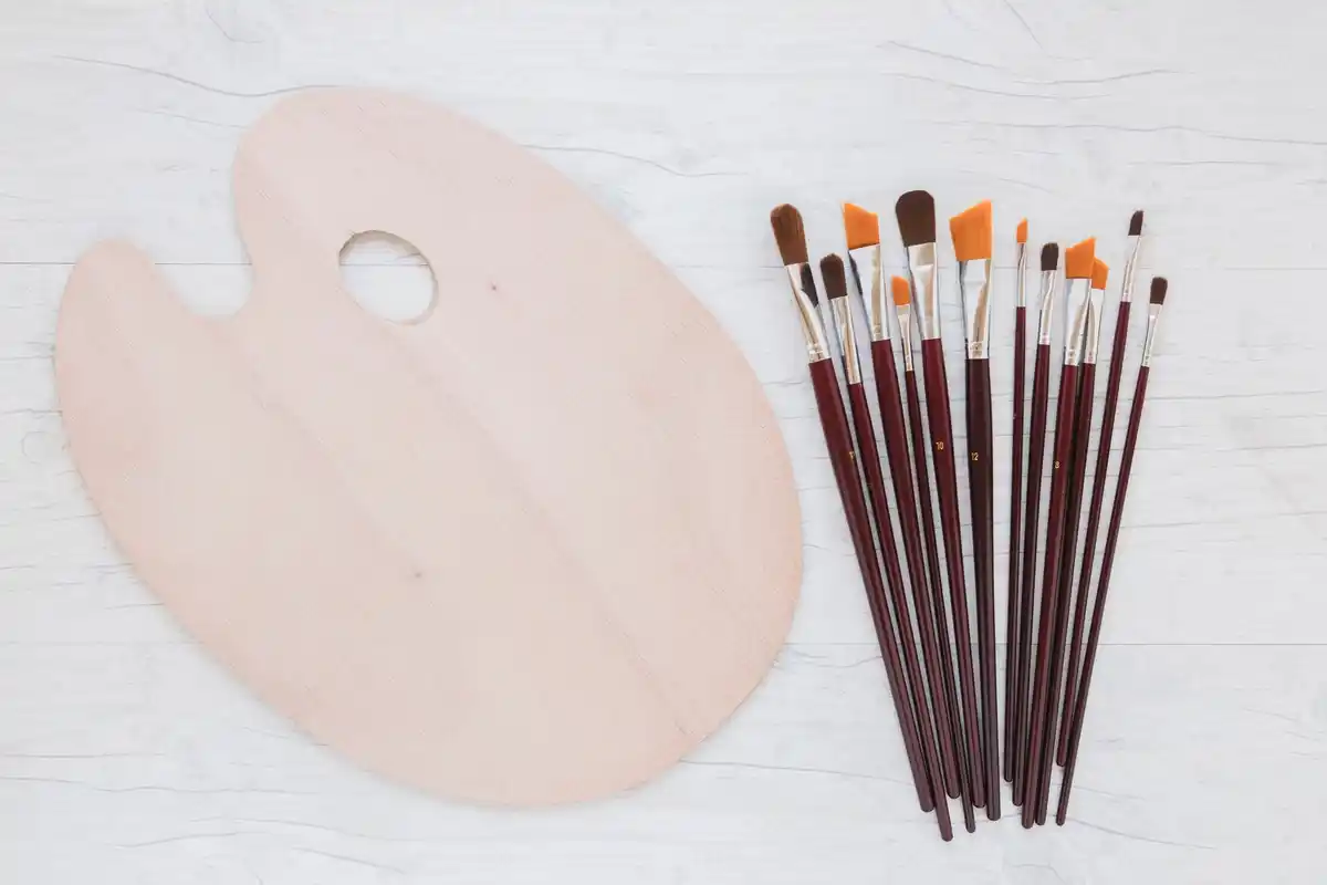 cheap paintbrushes on wooden table