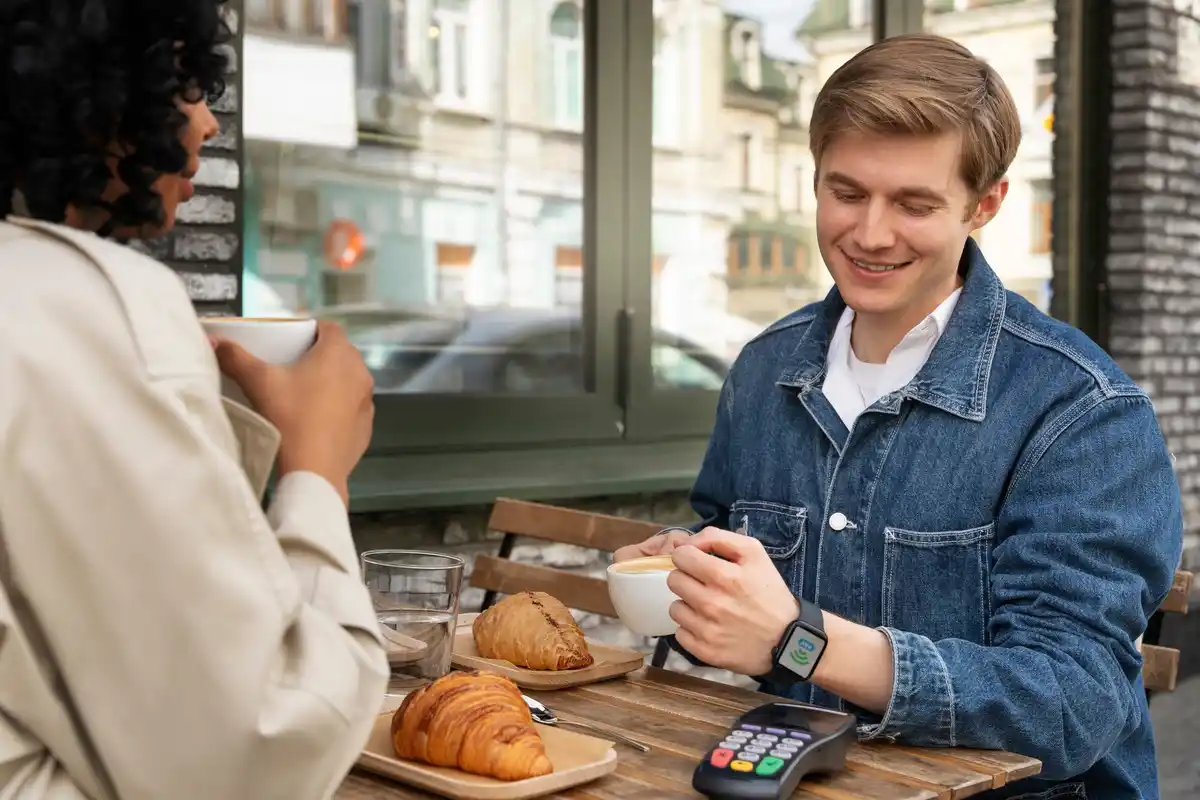 Czech millennials paying with phone in cafe