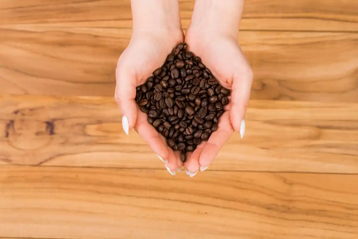 coffee grounds in hand for skincare