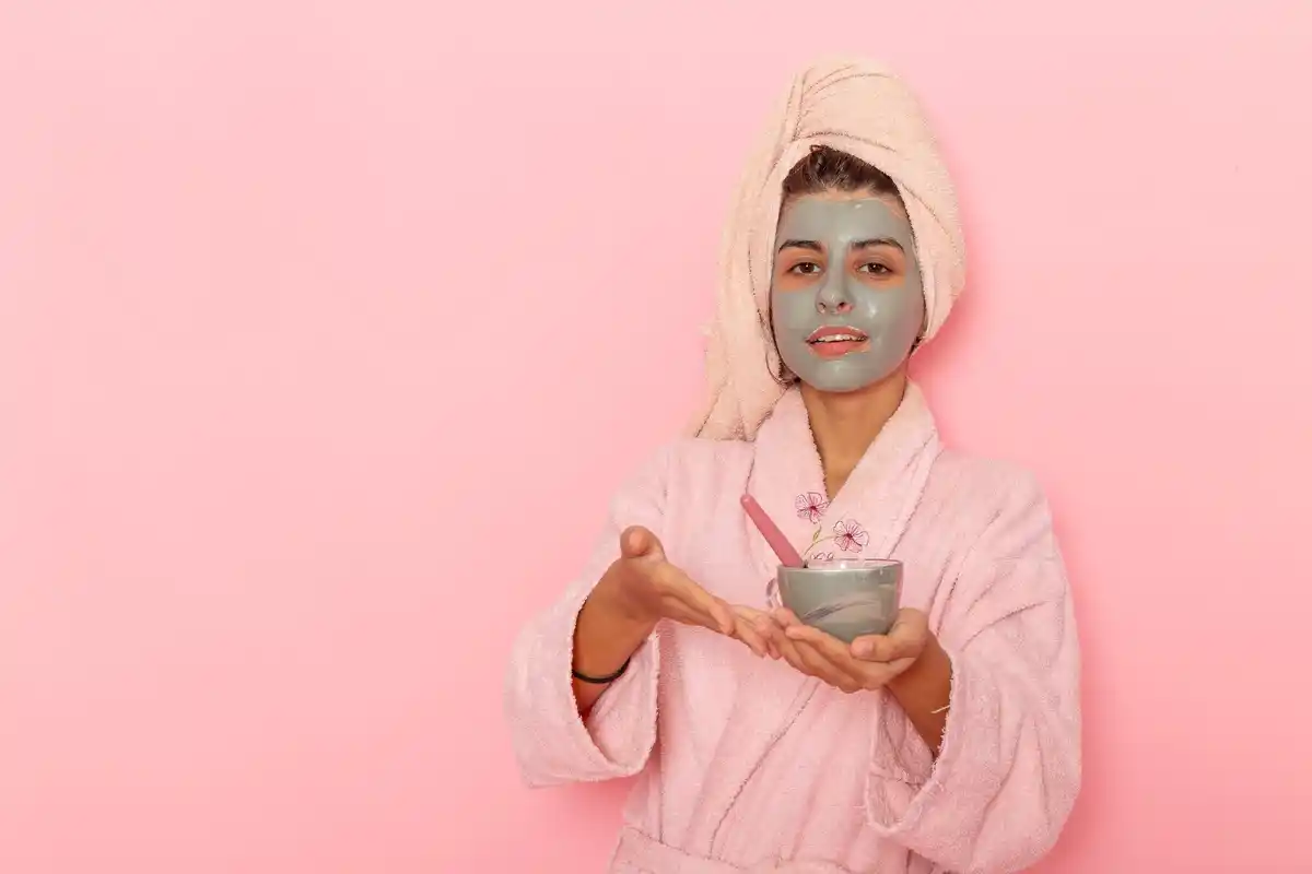 Czech woman applying homemade face mask bathroom