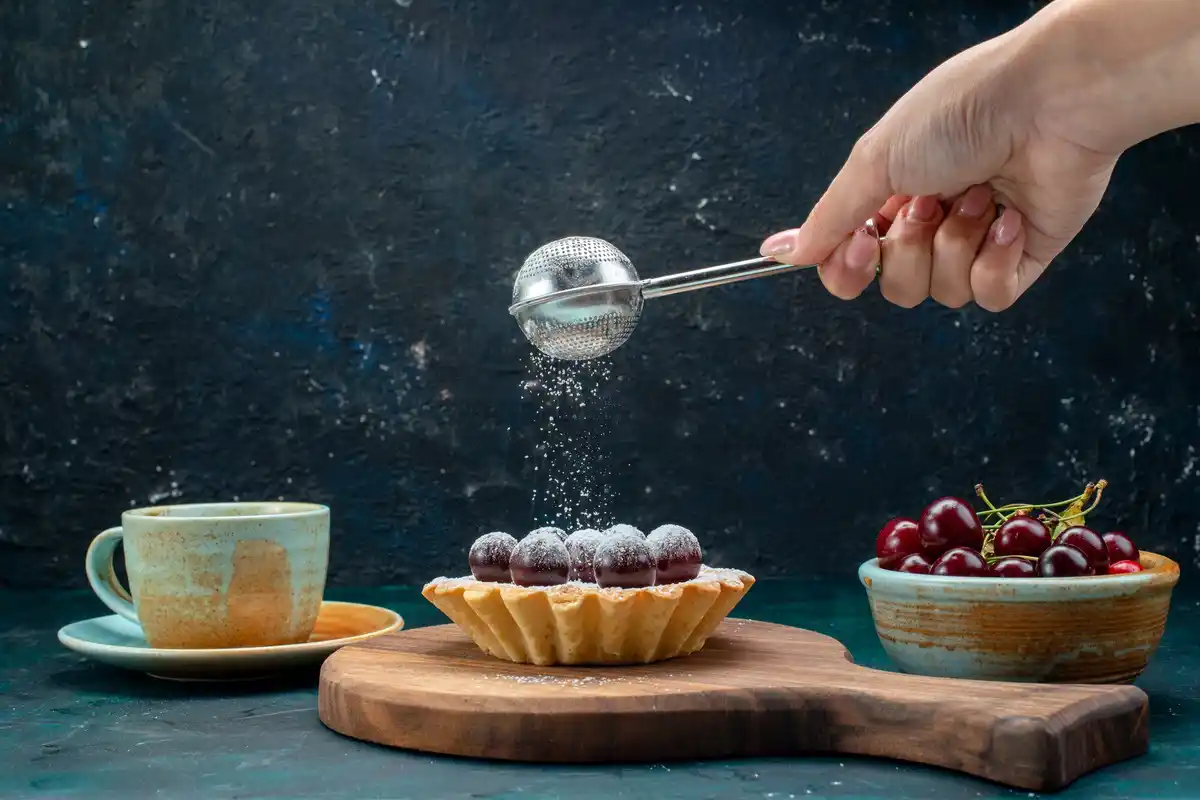 pouring ice cubes into hot frying pan kitchen