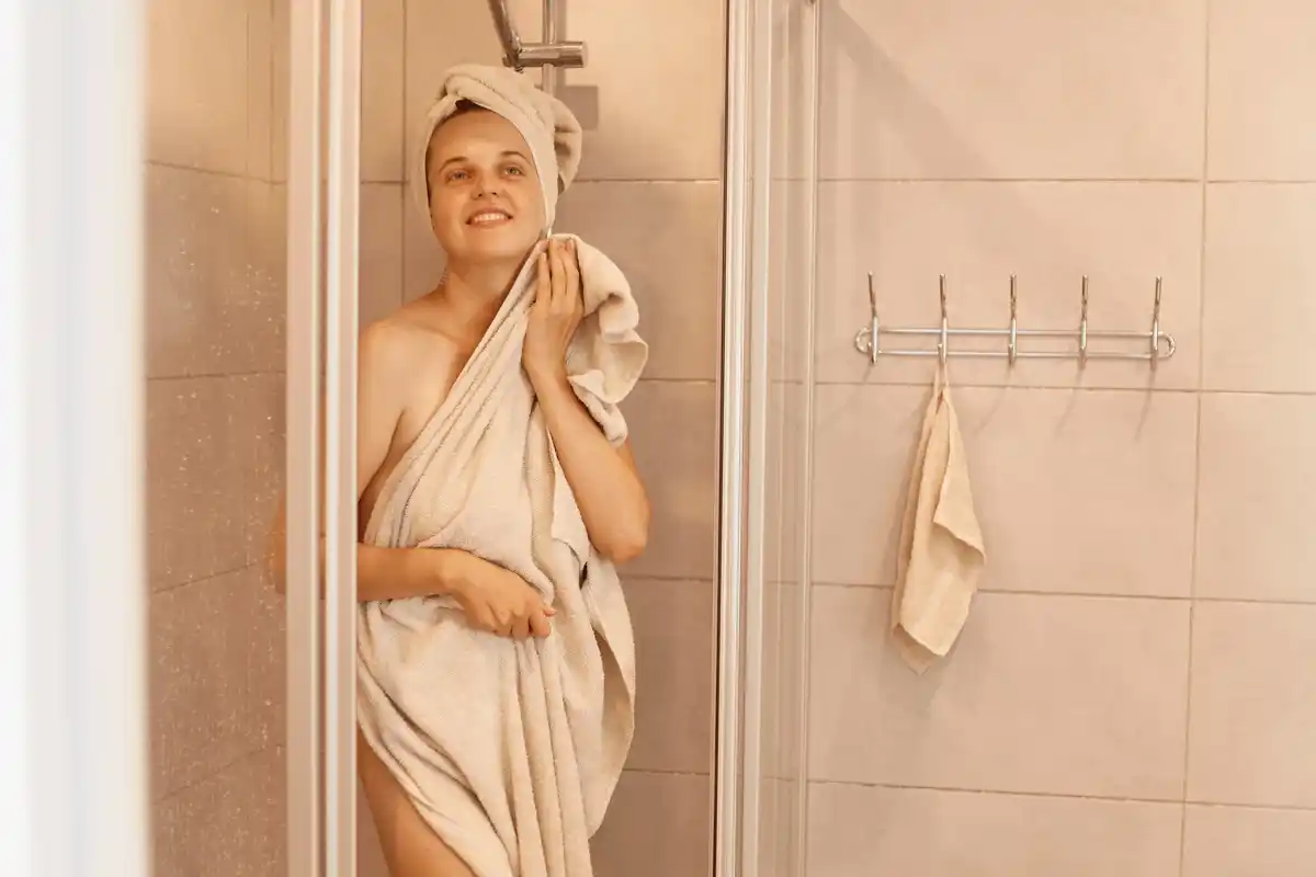 woman cold shower invigorating bathroom minimalism healthy lifestyle
