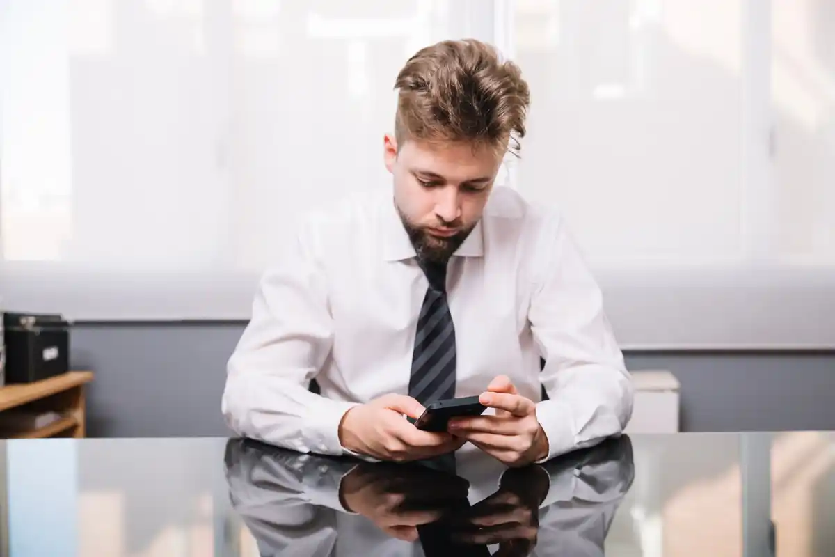 businessman checking email smartphone modern office