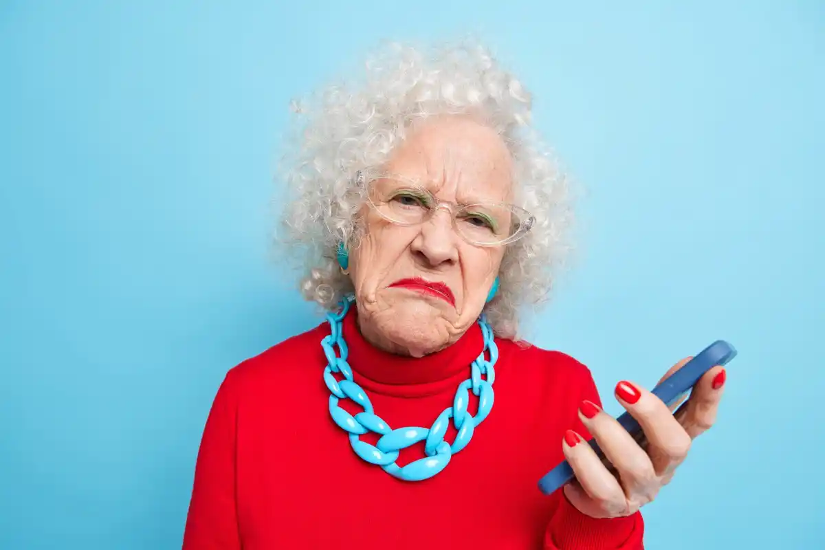 senior listening to phone reading message out loud