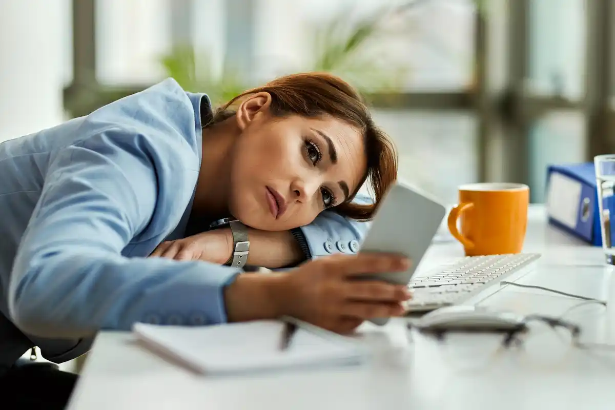 tired czech office worker during break smartphone