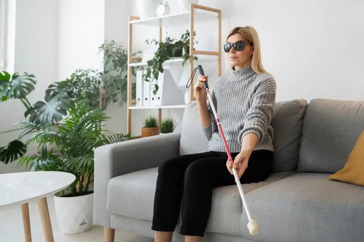 elderly woman using telescopic mop in modern Czech apartment