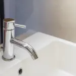 limescale buildup Czech bathroom faucet close up