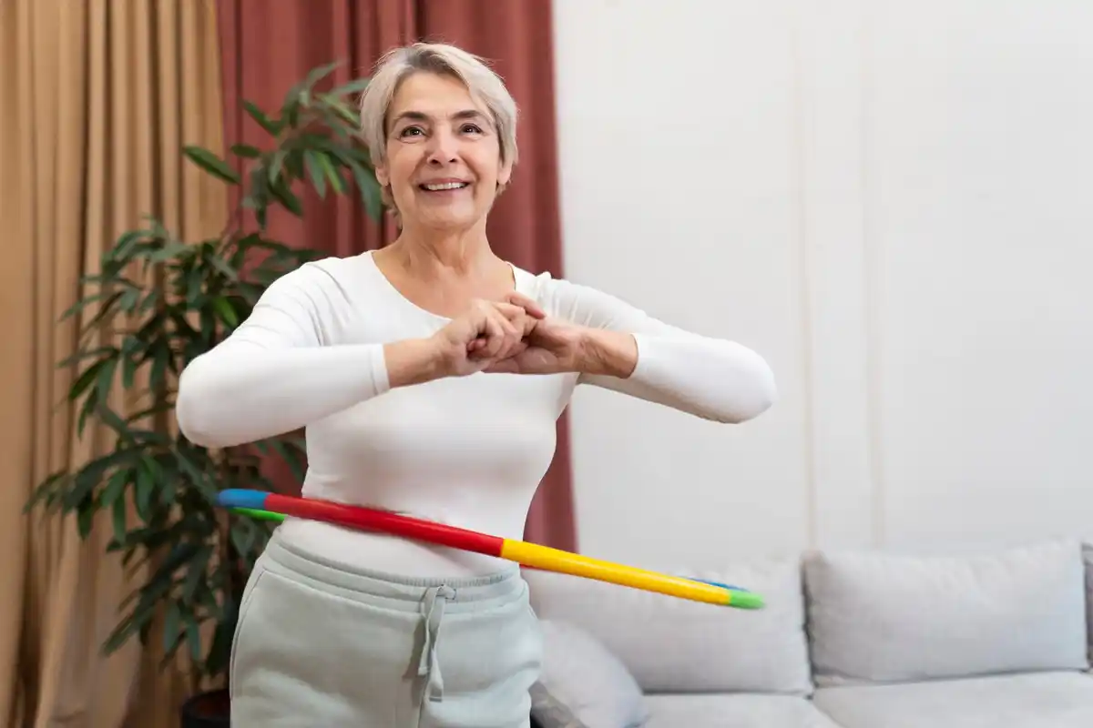elderly woman cleaning Czech home with back pain prevention