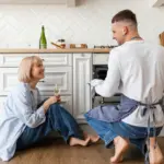 unhappy couple sitting in silence kitchen