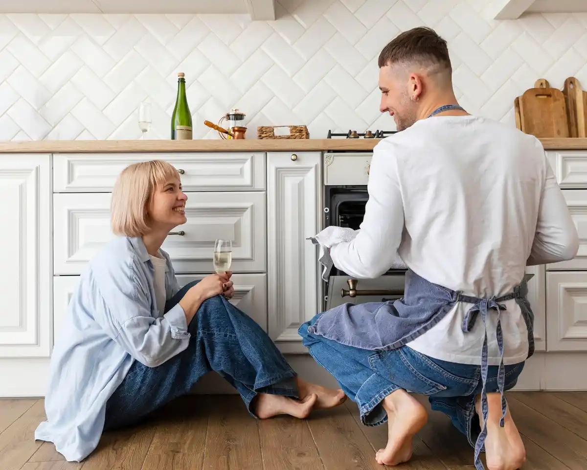 unhappy couple sitting in silence kitchen