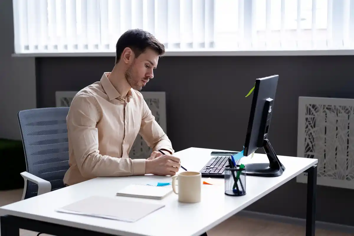 Japanese man with a checklist at work desk