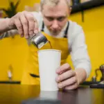 barista adding salt to coffee