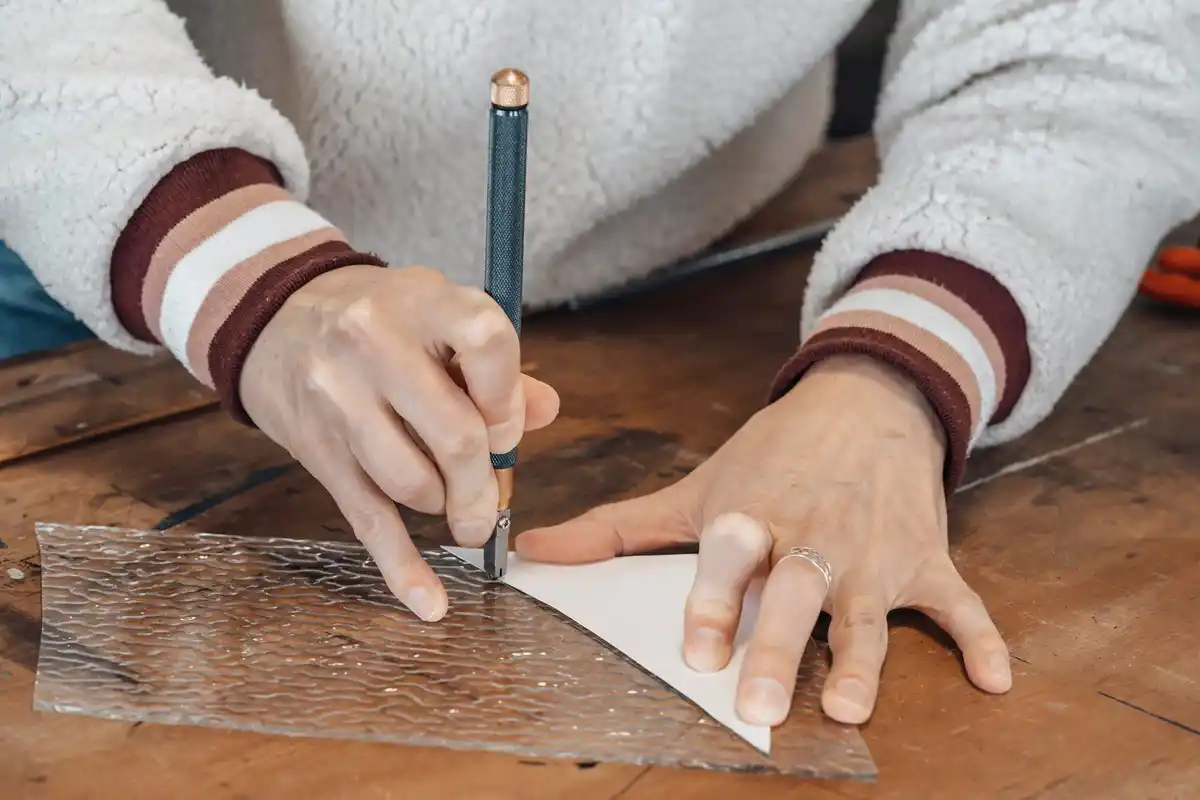 hand sealing window crack with plasticine