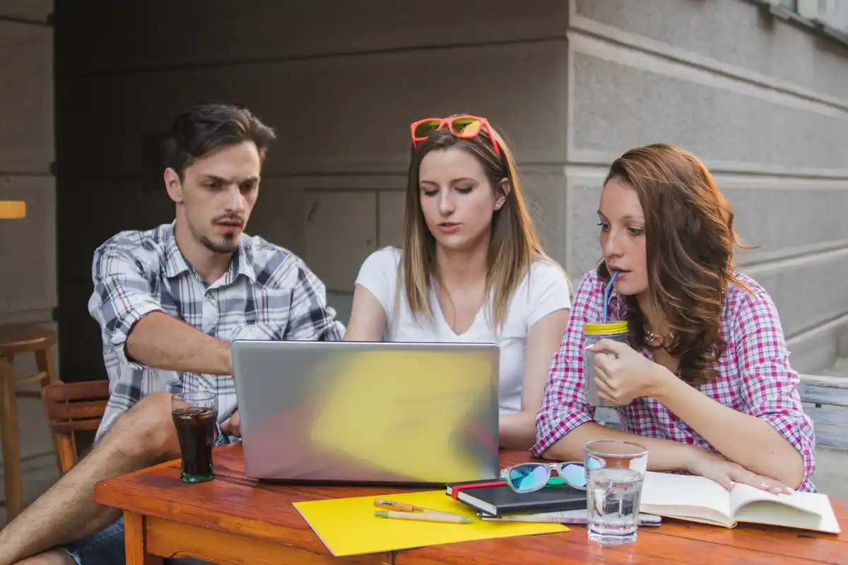 young czech people planning together notebook cafe