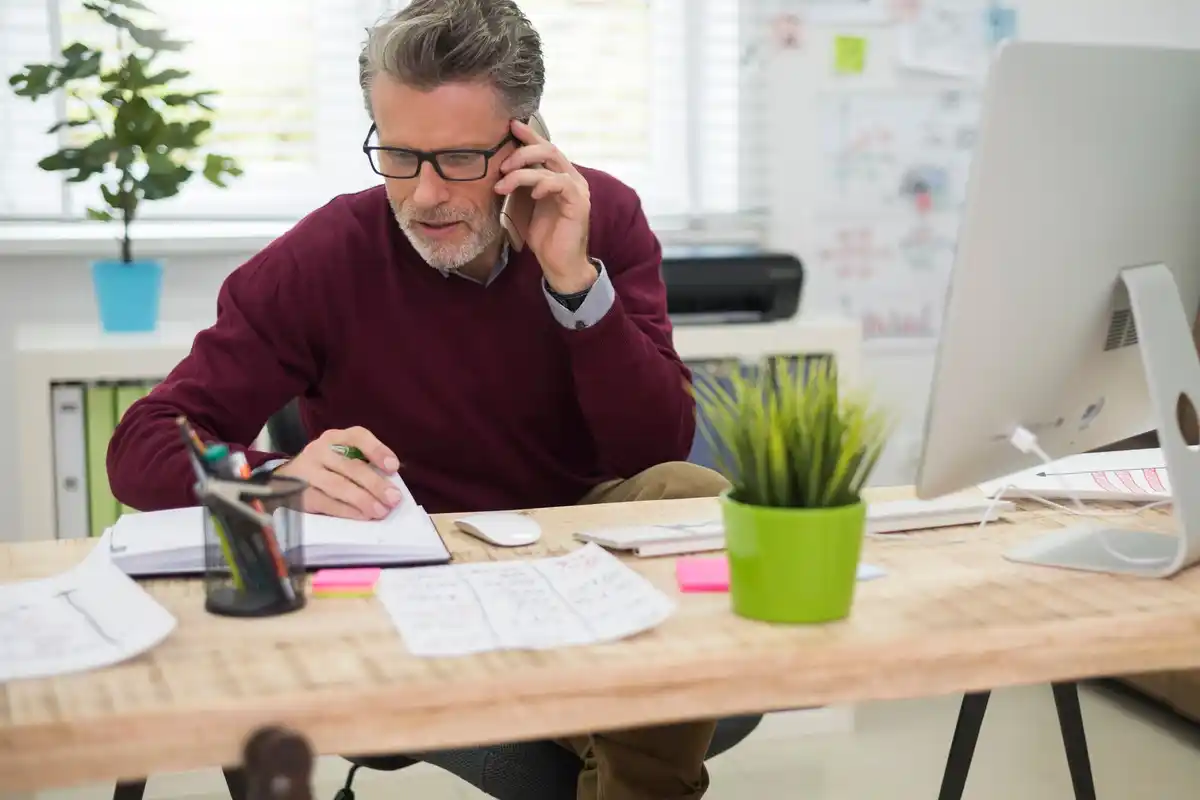 middle aged professional working office desk organized time blocking