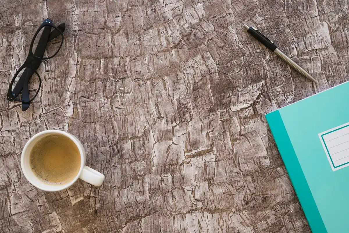 workplace desk with crumpled papers and coffee mug