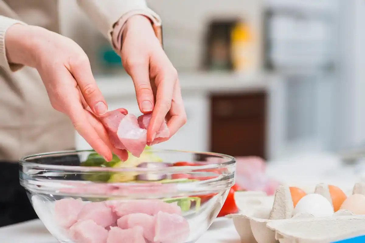 frozen raw meat defrosting in water bowl kitchen