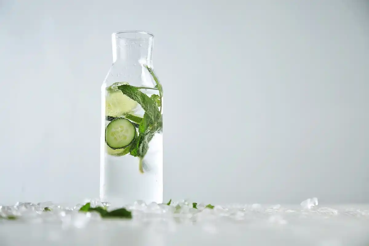 fresh herbs in glass of water in fridge