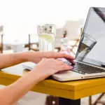 people buying plane tickets early morning coffee laptop
