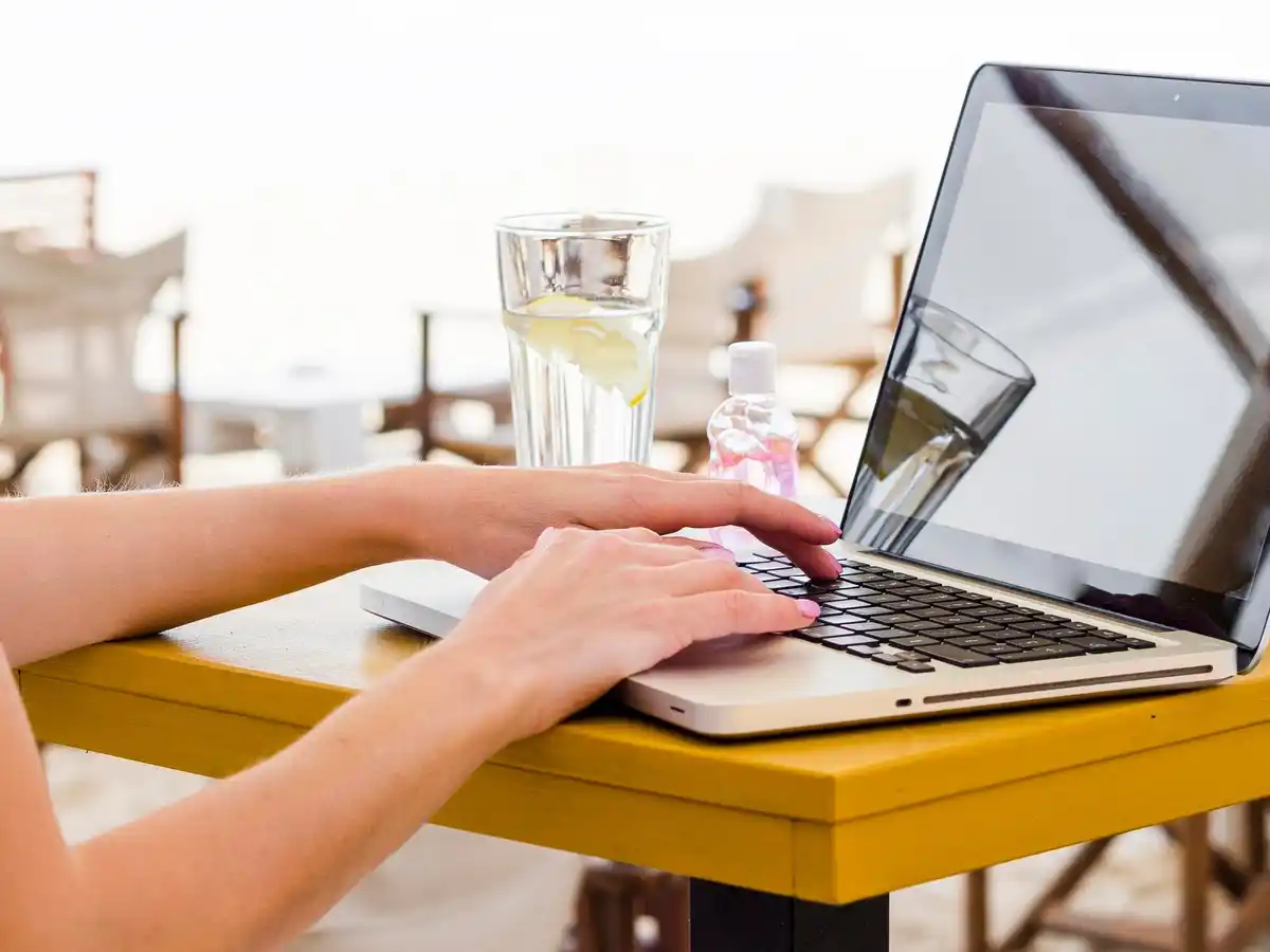 people buying plane tickets early morning coffee laptop