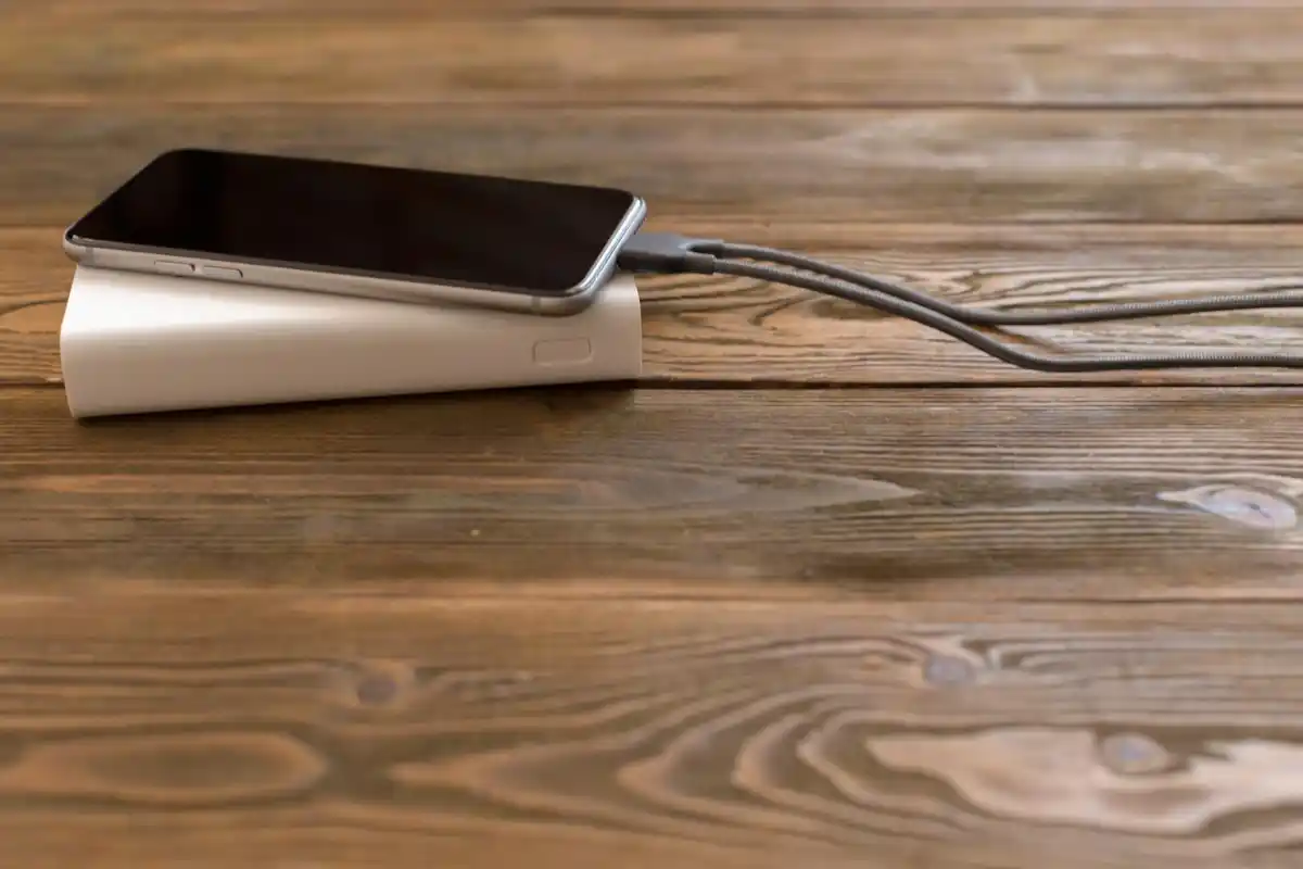 damaged phone battery close up charging cable night