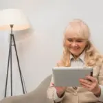 elderly using tablet in modern home