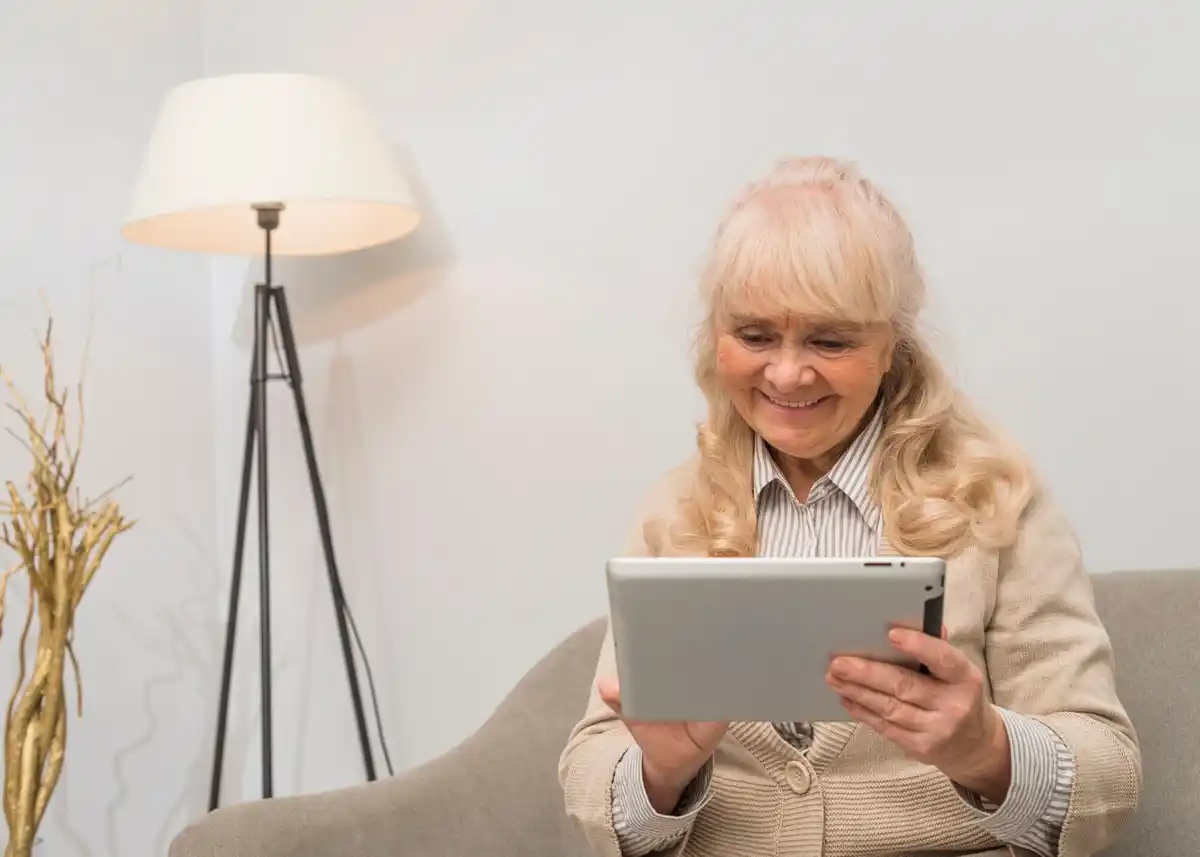 elderly using tablet in modern home