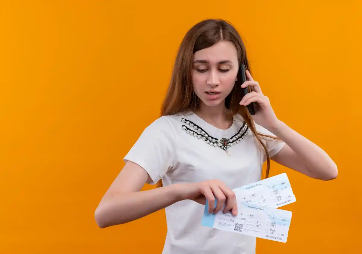 buying airline tickets on tuesday, over shoulder, czech currency, airport, phone