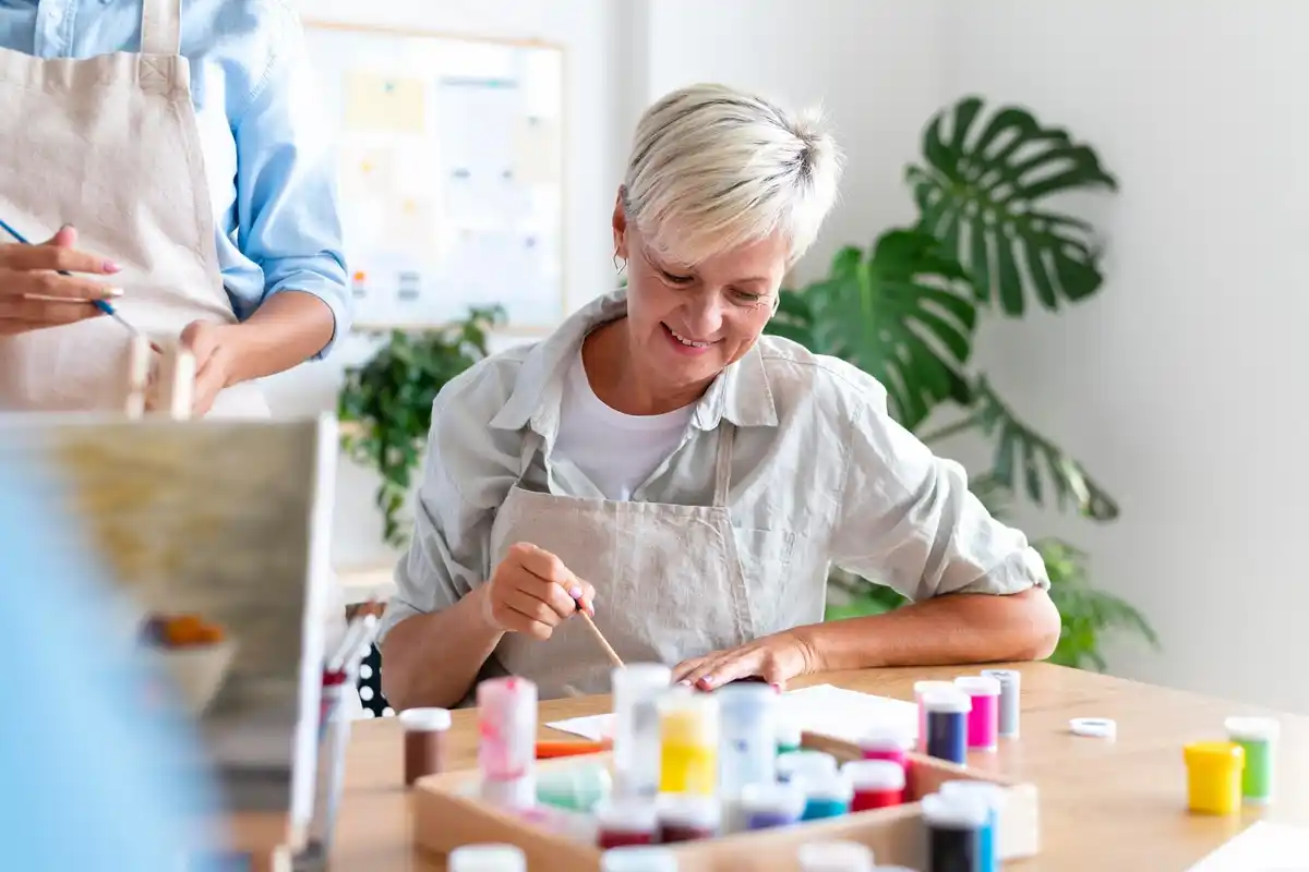 elderly woman making collages at home, colorful, cozy, Czech apartment