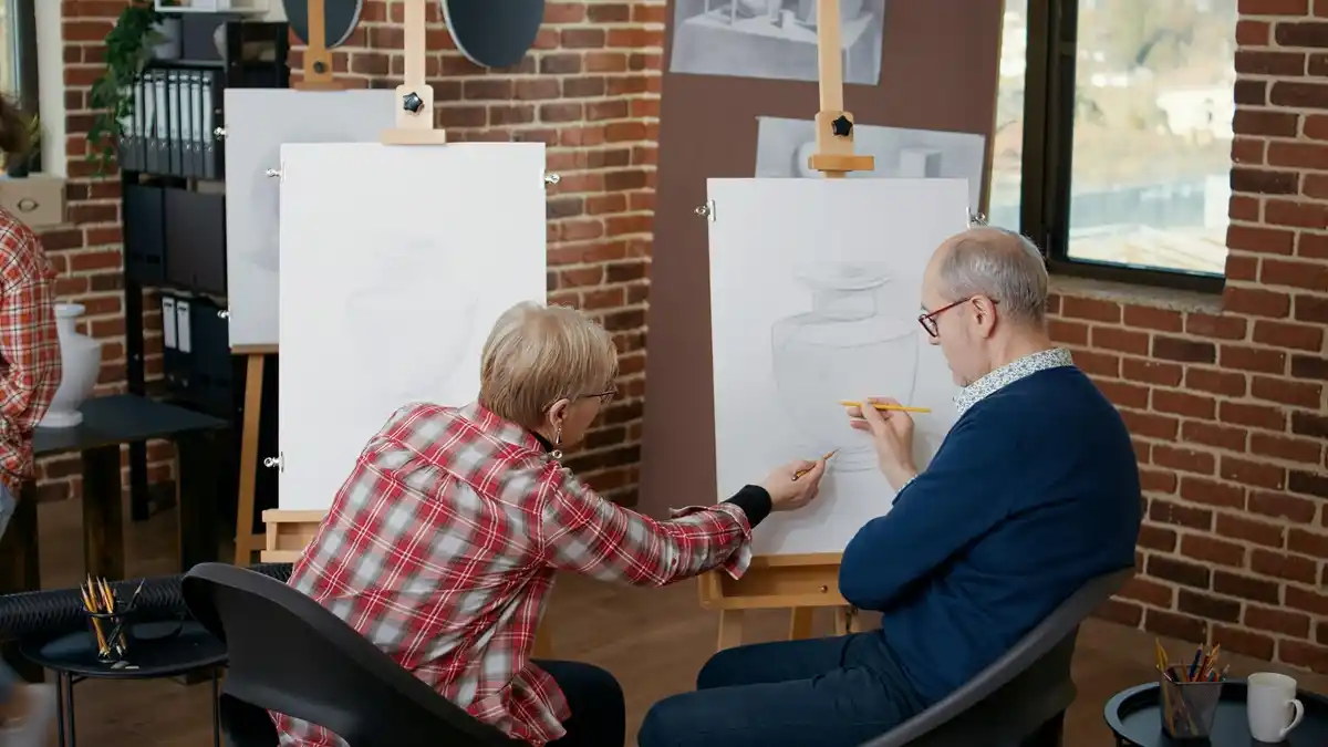 Czech seniors painting together at a light-filled workshop, creative mood, Prague