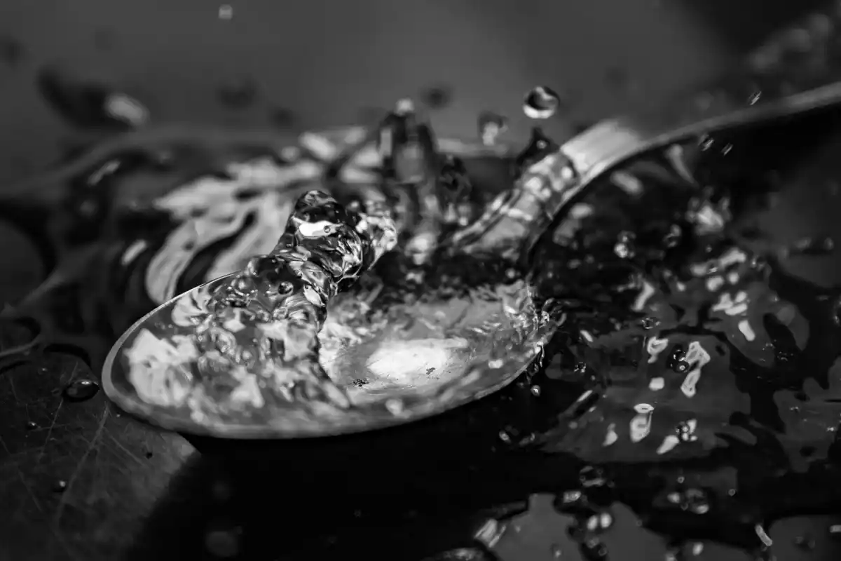 closeup modern water running over dirty dishes in sink prague apartment